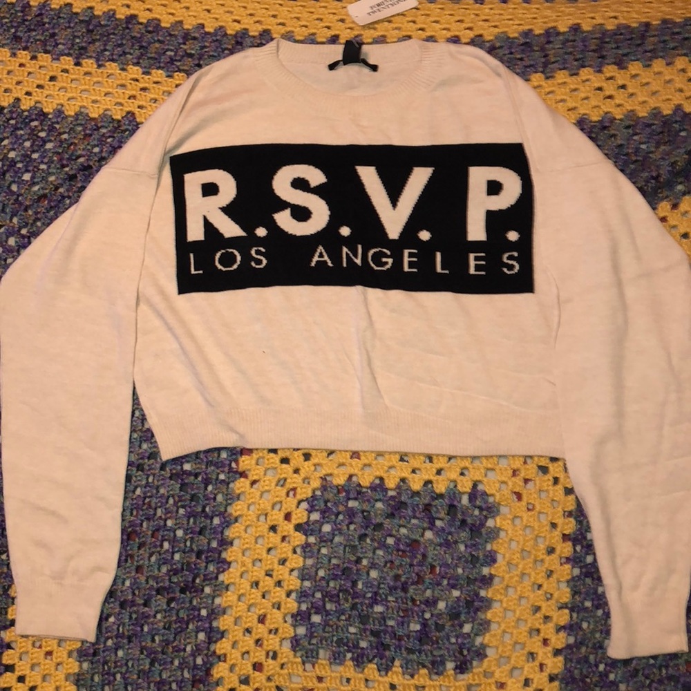 Cropped cream and black sweater.